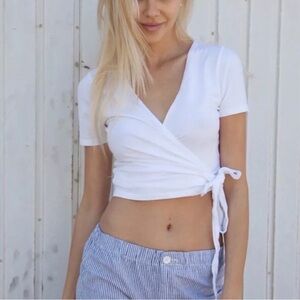 Brandy Melville white shirt with tie on the side! Pre loved! In great condition.